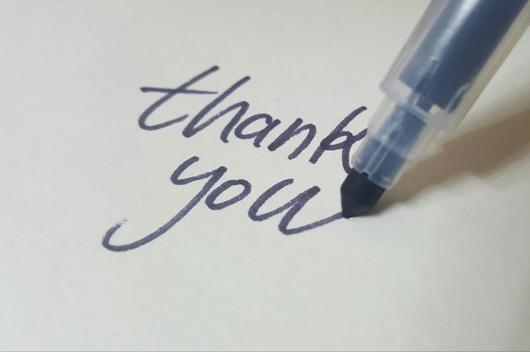 Pen Writing Thank You on White Background